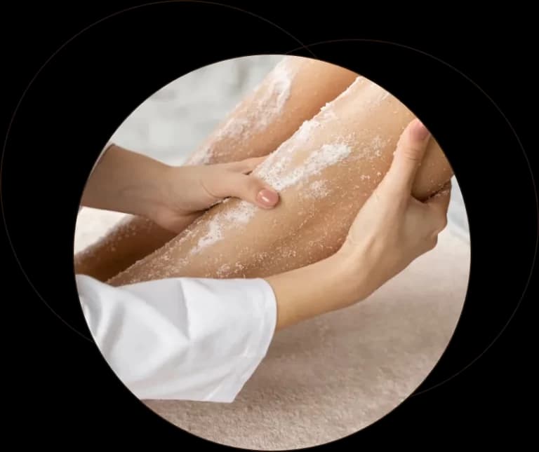 A therapist working on a client's hands during a treatment