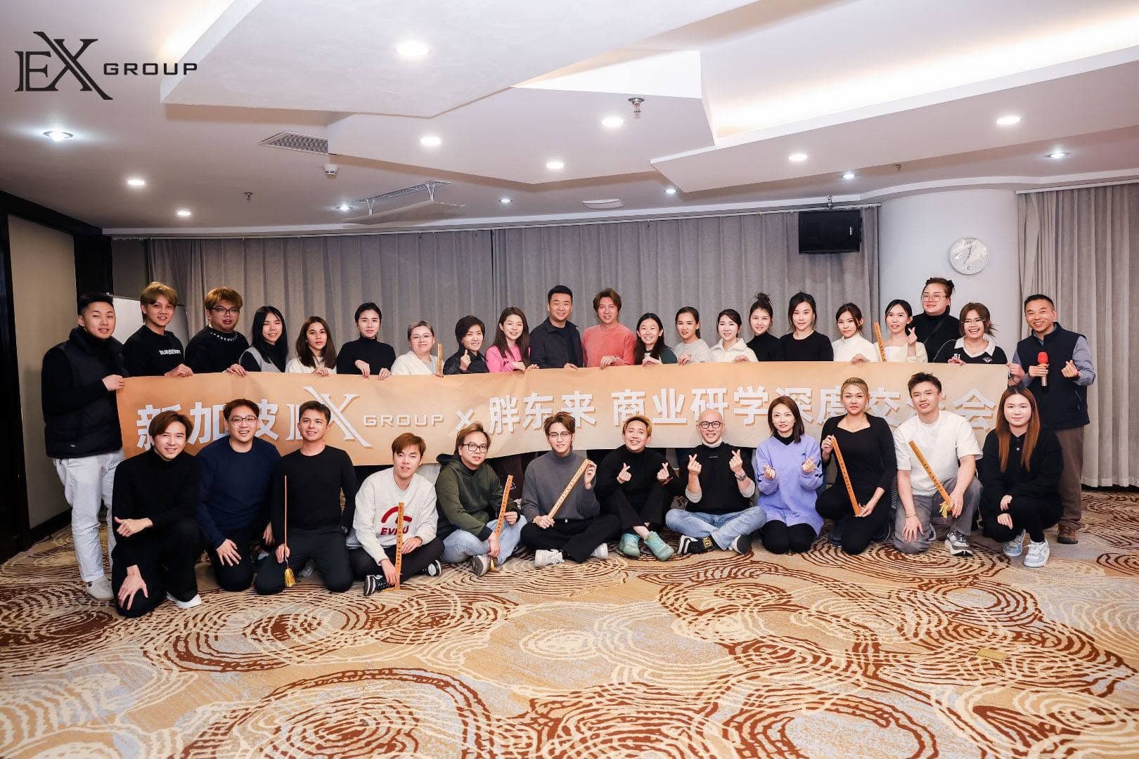 The EX Group team photographed together at a business study exchange